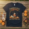 Pumpkin Spice And Everything Nice text with a cute cat, pumpkins, and fall leaves graphic on a navy t-shirt