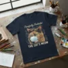 Purrfectly Protected THE CAT'S MEOW t-shirt featuring a calico cat wearing a face mask and playful text