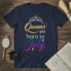 Queens are born in July text with a sparkling crown graphic on a navy blue t-shirt