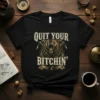 Black t-shirt with "Quit Your Bitchin'" text above a roaring bear graphic and mining tools