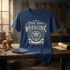 Quit Your Whinging T-Shirt with a distressed vintage lion graphic and ornate text