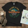 Black t-shirt with "Welcome to Camp Quitcherbitchin If You're Not A Happy Camper Take A Hike" text, RV, campfire, and