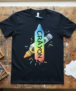 Rainbow CRAYON text on a black t-shirt, with colorful crayon graphics and splatters
