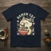 Ramen Cat T-Shirt design featuring a cute cat eating ramen with chopsticks, surrounded by cherry blossoms and the text "RAMEN