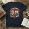Read Your Heart Out t-shirt design featuring anthropomorphic book and heart characters surrounded by roses and vintage scrollwork