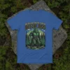 Realer Than Your Bitch Ass Bigfoot T-Shirt with a green Bigfoot graphic and mountain forest scene