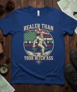 Bigfoot walking in front of an American flag and mountains with text "Realer Than Your Bitch Ass" on a blue