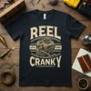 T-shirt design with text "REEL LITTL LINEL CRANKY" and an illustration of a fishing reel