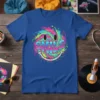 Vibrant tie-dye smiley face graphic with the word SMILE in bold letters on a blue t-shirt