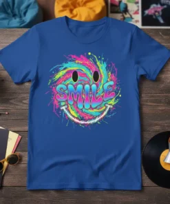 Vibrant tie-dye smiley face graphic with the word SMILE in bold letters on a blue t-shirt