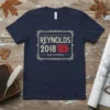 Navy t-shirt featuring "REYNOLDS 2018 IOWA GOVERNOR" text and an outline of Iowa map graphic