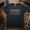Rheumatologist definition t-shirt with gold text: "RHEUMATOLOGIST noun. [roo-muh-tol-uh-jist] Like a normal doctor, only way cooler."