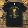 Rise & Shine It's Mimosa Time text with a mimosa glass graphic on a black t-shirt