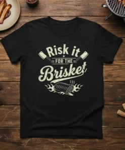 Black t-shirt with "Risk it FOR THE Brisket" text, cleavers, and a smoking brisket graphic