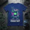 Rock Out With Your Coqui Out t-shirt featuring a green frog wearing American flag sunglasses, making a rock hand gesture