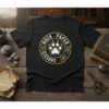Rock Paper Cissors text around a white paw print graphic on a black t-shirt