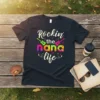 T-shirt with "Rockin' the nana life" text, colorful guitars, and musical notes
