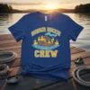 Rubber Duckie Crew t-shirt design featuring a wooden boat filled with rubber ducks on blue waves, with the text "RUBBER