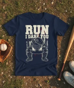 Navy blue t-shirt with "RUN I DARE YOU" text and a baseball catcher graphic, on a distressed American flag background