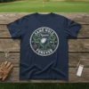 Navy t-shirt with "SAME HOLE Champion ESTD. 2025 FOREVER" text, golf ball, and clubs graphic design