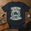 Sancho Plumbing Laying Pipe Night t-shirt design featuring cartoon plumbers and tools with bold typography