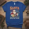 Blue t-shirt design with vintage-style illustration of Santa Claus playing a banjo, text reads "SANTA playing banjo"
