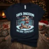 Santa Smackdown Holiday Hypefight t-shirt design featuring two Santas wrestling in a snowy ring with candy cane corner posts