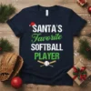 Santa's Favorite Softball Player text with Christmas hat and baseball graphic on a dark navy t-shirt