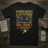 Black t-shirt with bold yellow and orange text: SARCASM & ATTITUDE much cheaper than BAIL MONEY & THERAPY, featuring a