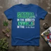 Sativa in the Streets Indica in the Sheets quote on a royal blue t-shirt, featuring green neon text and decorative
