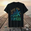 Save The Turtles graphic t-shirt with a central sea turtle and smaller turtles, set against a sunset ocean background