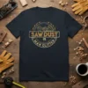 Saw Dust Is Man Glitter quote on a dark t-shirt, featuring gears and woodworking tools graphic