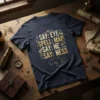 Navy blue t-shirt with gold text: SAY: EYE SPELL: MAP SAY: NE SAY: NESS, featuring fantasy map and dragon graphics