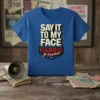 Blue t-shirt with "SAY IT TO MY FACE HARRIS for President" text in bold white and red lettering, featuring a