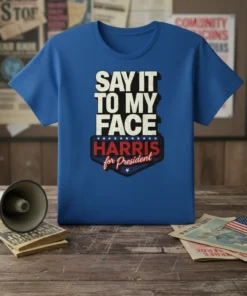 Blue t-shirt with "SAY IT TO MY FACE HARRIS for President" text in bold white and red lettering, featuring a