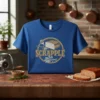 Scrapple T-Shirt featuring a vintage circular design with the word SCRAPPLE, a slice of scrapple in a pan, and herbs