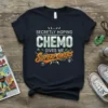 Secretly Hoping Chemo Gives Me Superpowers quote on a navy t-shirt, featuring bold typography and graphic elements