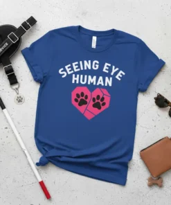 Seeing Eye Human t-shirt with white text and pink heart graphic with paw prints