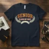 SENIOR CLASS OF 2021 text with laurel wreath and ribbon graphic on a navy t-shirt