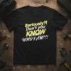 Black t-shirt with yellow and white text that reads "Seriously?! Don't you KNOW WHO I AM??!"