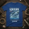 Shark Week 2024 t-shirt design with a great white shark breaching water. Text reads "SHARK WEEK 2024"