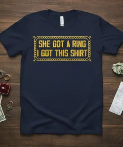 She Got A Ring I Got This Shirt text design with gold chain border on a navy t-shirt