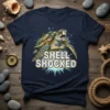 Sea turtle with "Shell Shocked" text, splashing water graphic, navy t-shirt design
