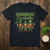 Shenanigans Coordinator text with three leprechauns holding gold coins and a key on a navy t-shirt for St. Patrick's Day