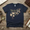 Shiza Inu Dandelion Wishes t-shirt design featuring fluffy dandelions and flying Shiba Inu puppies in a golden gradient
