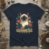 Geometric Siamese cat with blue eyes surrounded by teal and coral roses, text reads SIAMESE FLORALS on a navy t-shirt