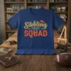 Sibbling SQUAD text design with decorative elements and two red hearts on a blue t-shirt