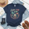 Sister TRIP MAKING MEMORIES TOGETHER text with a cruise ship, palm trees, and sunset graphic on a navy blue t-shirt
