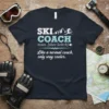 Navy t-shirt with white and blue text reading "Ski Coach, noun. [skee kohch], Like a normal coach, only way cooler"