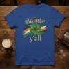 Sláinte y'all text with a green clover and Irish flag stripes on a blue t-shirt for St. Patrick's Day
